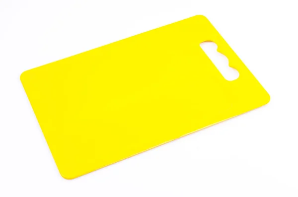 Yellow plastic cutting board — Stock Photo, Image