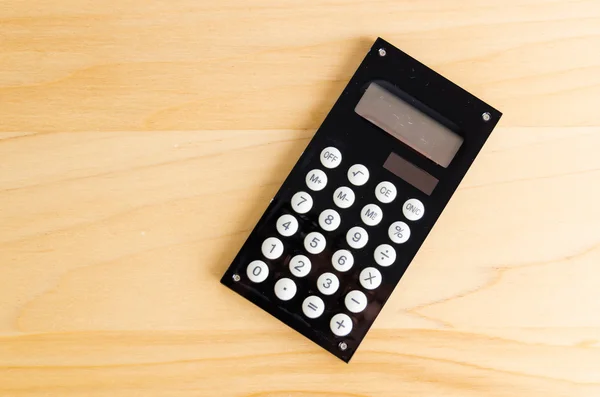 Calcolatrice su tavola di legno — Foto Stock