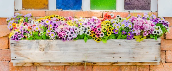 Plastic flower in vase on wall background — Stock Photo, Image