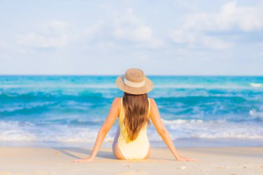 Güzel bir Asyalı kadının portresi. Rahatlayın. Plaj okyanusunda tatil yaparken gülümseyin.