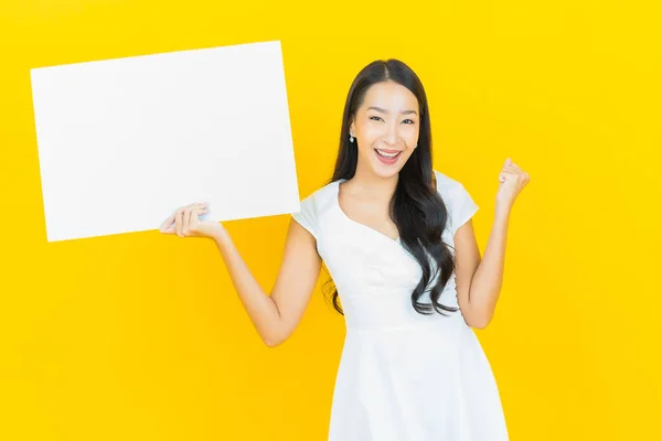노란색 배경에 광고판이 아름다운 아시아 여자의 — 스톡 사진