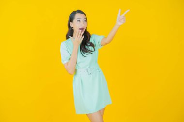 Portre güzel Asyalı kadın gülümsüyor. Renkli arka planda hareket var.