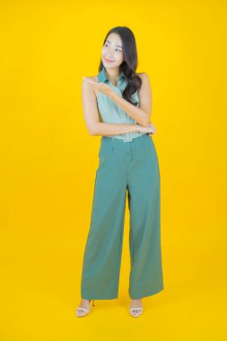 Portre güzel Asyalı kadın gülümsüyor. Renkli arka planda hareket var.