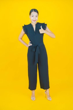 Portre güzel Asyalı kadın gülümsüyor. Renkli arka planda hareket var.