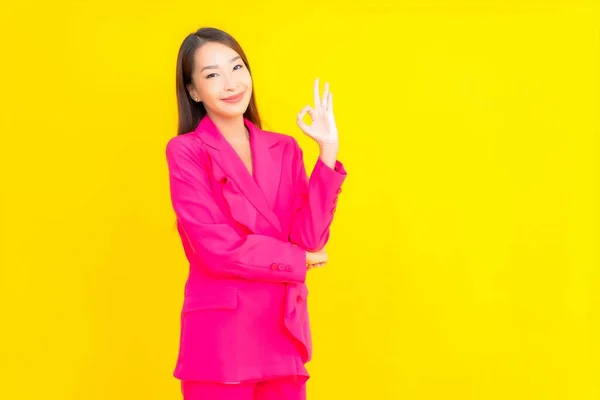 Güzel Bir Asyalı Kadın Sarı Arka Planda Gülümsüyor — Stok fotoğraf