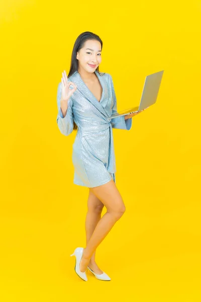 Portrait Beautiful Young Asian Woman Smile Computer Laptop Yellow Isolated — Stock Photo, Image