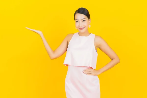 Asyalı Güzel Bir Kadının Portresi Sarı Arka Planda Hareketli Gülümsüyor — Stok fotoğraf