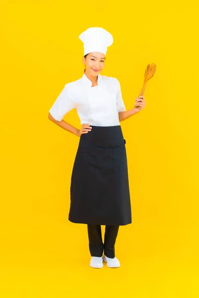 Portrait Beautiful Young Asian Chef Woman Spatula Yellow Isolated Background — Stock Photo, Image