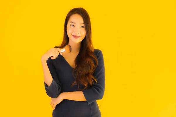 Retrato Bela Jovem Asiático Mulher Com Maquiagem Escova Amarelo Isolado — Fotografia de Stock