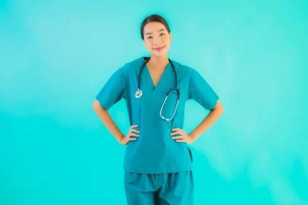 Portrait beautiful young asian doctor woman happy smile for work in hospital and clinic on blue isolated background