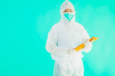 Güzel, genç Asyalı doktor kadın koronavirüsten korunmak için ppe ya da kişisel koruyucu ekipman takıyor ya da mavi izole arka planda beyaz kartı olan 19. bölgede yaşıyor.