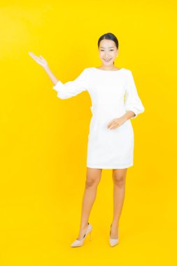 Portre güzel Asyalı kadın gülümsüyor. Renkli arka planda hareket var.