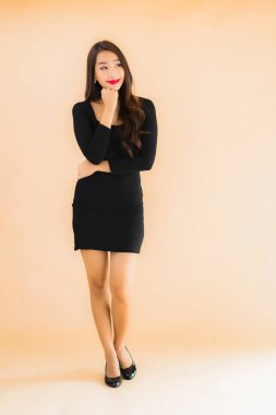 Güzel Asyalı genç bir kadının portresi mutlu bir gülücük renkle izole edilmiş arka planda.