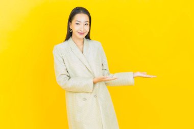 Portre güzel Asyalı kadın gülümsüyor. Renkli arka planda hareket var.