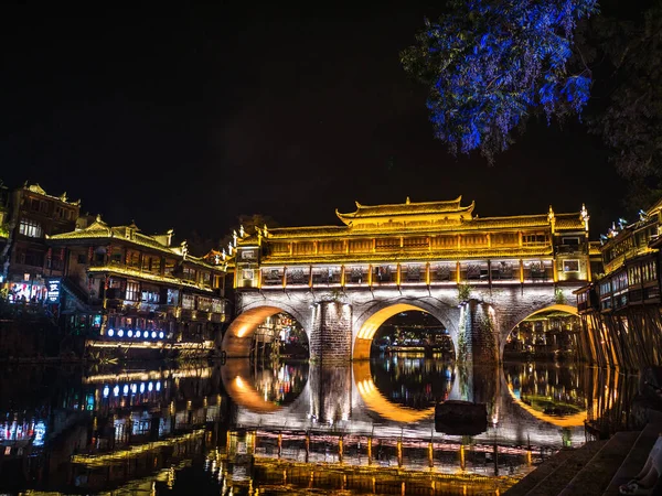 stock image Scenery view of hong bridge and building in the night of fenghuang old town .phoenix ancient town or Fenghuang County is a county of Hunan Province, China