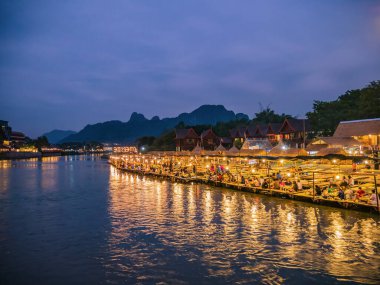 Vangvieng/lao-4 Dec 2017:Beautiful view of nam song river with riverside restaurant and the mountain in the night at Vangvieng city Lao.Vangvieng City The famous holiday destination town in Lao.