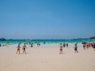 Chonburi/Thailand - 20 apr 2019:Unacquainted Tourists in Tropical Idyllic Ocean and Boat on Koh lan Island in vacation time. Koh lan island is the Famous island near Pattaya city thailand