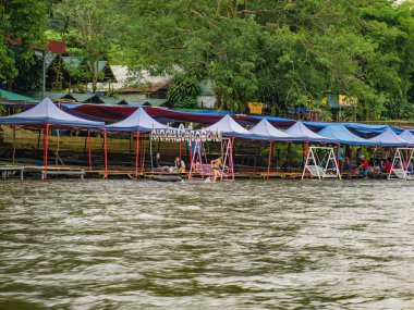Vangvieng/lao-10 Dec 2017:Unacquainted tourist Sitting at riverside restaurant on namsong river at vangvieng city Laos.Vangvieng City The famous holiday destination town in Lao.