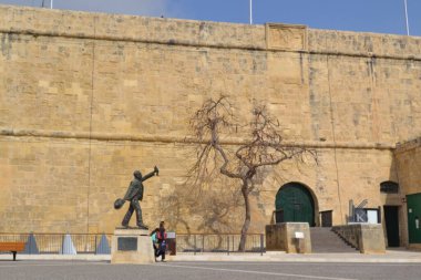 people on the streets of city. Maltese architecture buildings and houses in city