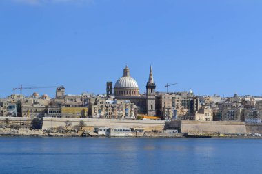 View from above of the golden domes of churches and roofs with church of Our Lady of Mount Carmel and St. Paul's Anglican Pro-Cathedral, Valletta, Capital city of Malta