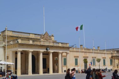 people on the streets of city. Maltese architecture buildings and houses in city