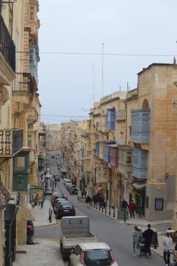 people on the streets of city. Maltese architecture buildings and houses in city