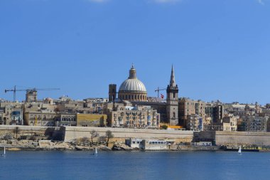 View from above of the golden domes of churches and roofs with church of Our Lady of Mount Carmel and St. Paul's Anglican Pro-Cathedral, Valletta, Capital city of Malta