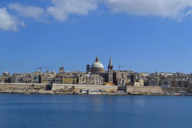 View from above of the golden domes of churches and roofs with church of Our Lady of Mount Carmel and St. Paul's Anglican Pro-Cathedral, Valletta, Capital city of Malta
