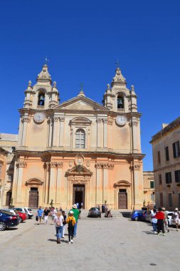 people on the streets of city. Maltese architecture buildings and houses in city