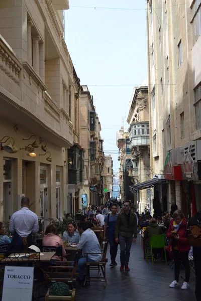 people on the streets of city. Maltese architecture buildings and houses in city