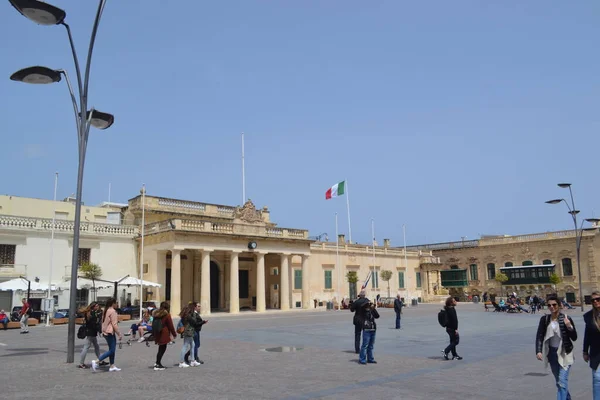 people on the streets of city. Maltese architecture buildings and houses in city
