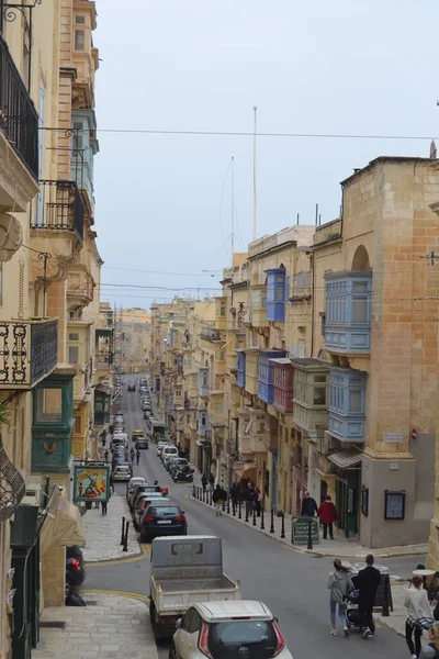 people on the streets of city. Maltese architecture buildings and houses in city
