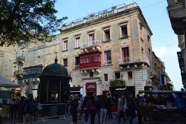 people on the streets of city. Maltese architecture buildings and houses in city