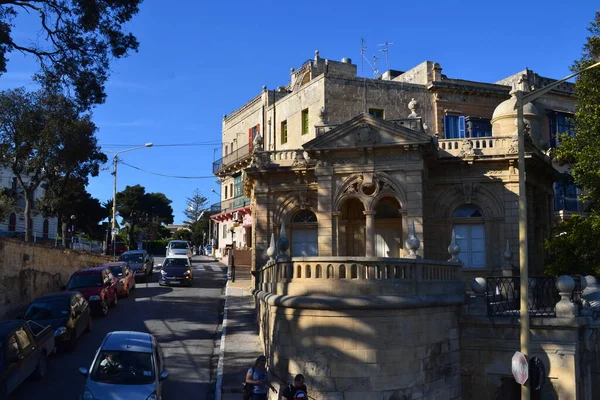 people on the streets of city. Maltese architecture buildings and houses in city