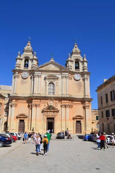 people on the streets of city. Maltese architecture buildings and houses in city