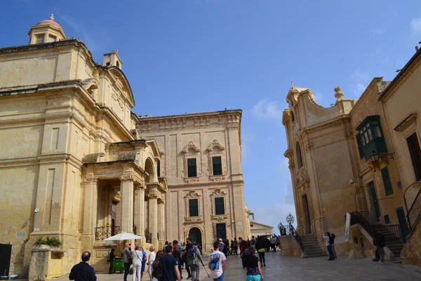 people on the streets of city. Maltese architecture buildings and houses in city