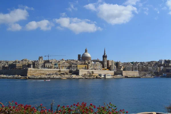 View from above of the golden domes of churches and roofs with church of Our Lady of Mount Carmel and St. Paul's Anglican Pro-Cathedral, Valletta, Capital city of Malta