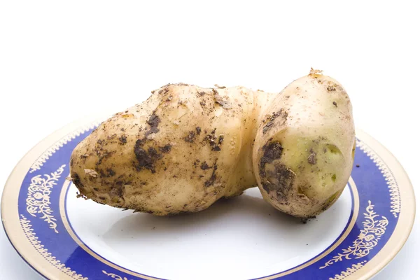 Brązowy ziemniaków na talerzu — Zdjęcie stockowe