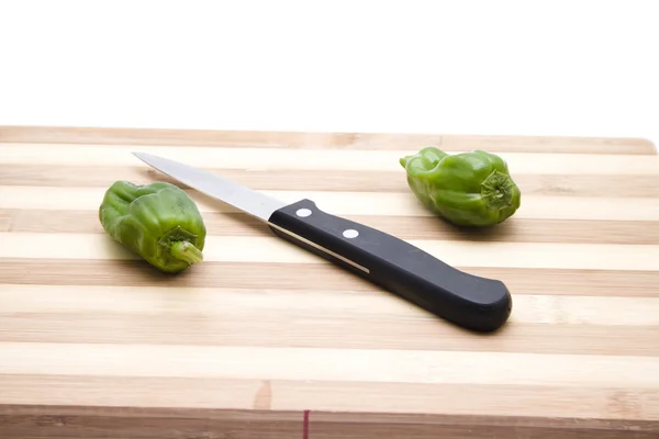 Capsicum with Knife on Wooden Plate — Stock Photo, Image