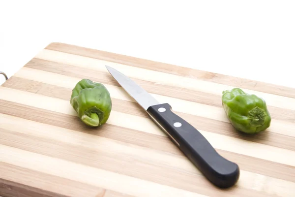 Capsicum with Knife on Wooden Plate — Stock Photo, Image