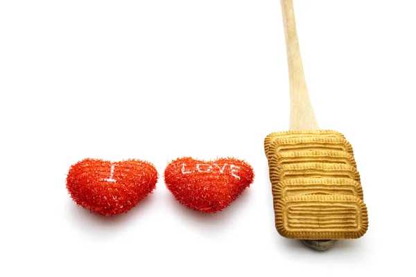 Fresh Baked Biscuits with red hearts on wooden spoon — Stock Photo, Image