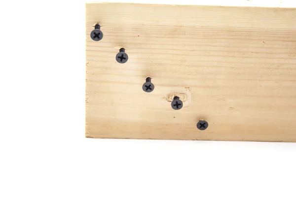 Drewniana tablica z czarnym śruby — Zdjęcie stockowe