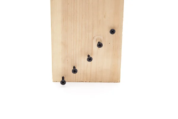 Drewniana tablica z czarnym śruby — Zdjęcie stockowe