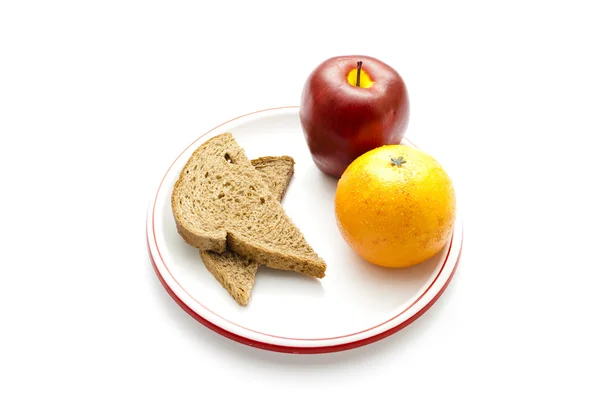 Mandarina naranja de plástico con tostadas de trigo integral y manzana de plástico —  Fotos de Stock