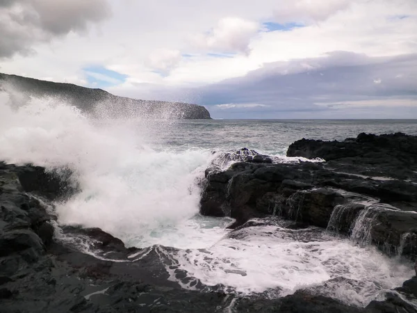 Dalgalar kayalara çarpıyor. Sao Miguel 'de rüzgarlı bir hava var, Azores. Piscinas Naturais Caneiros Doğal Parkı.