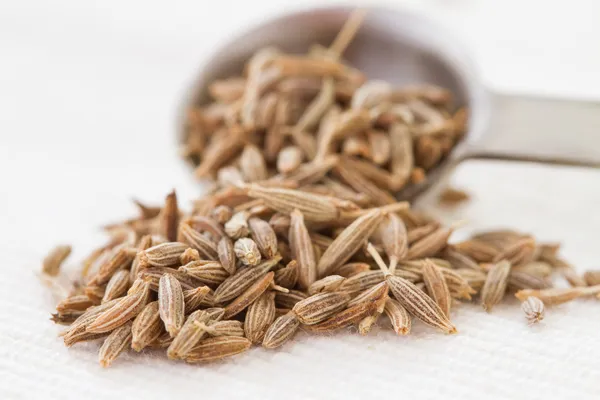 Cumin seeds and spoon — Stock Photo, Image