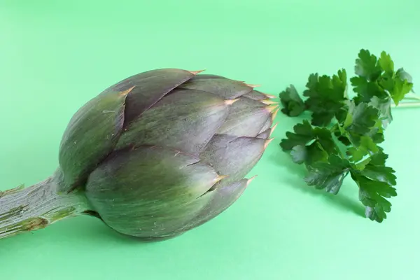 Artichokes on a green background — Stock Photo, Image