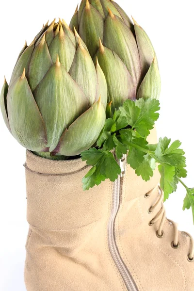 Artichokes in a women's boot — Stock Photo, Image