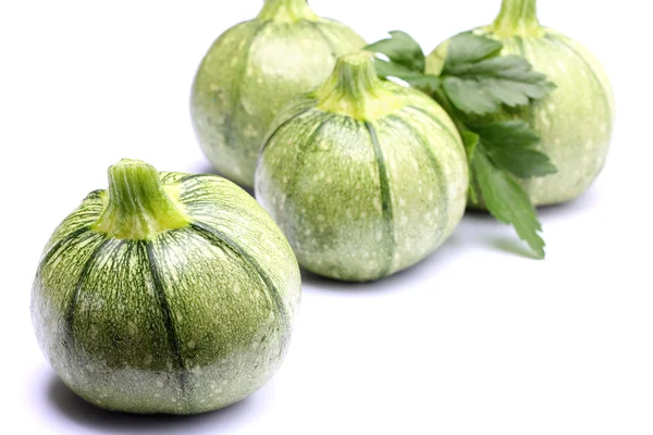 Round zucchini with parsley isolated on white — Stock Photo, Image