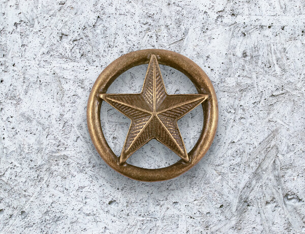 Bronze star on cement background